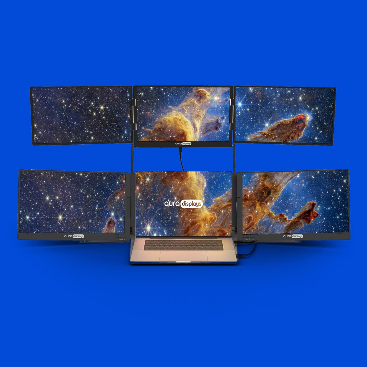 The Pillars of Creation wallpaper shown across six Aura Displays screens with a laptop